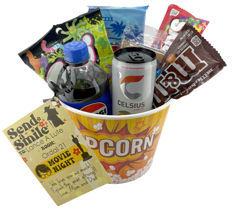 Popcorn bucket with snacks and a drink on a white background